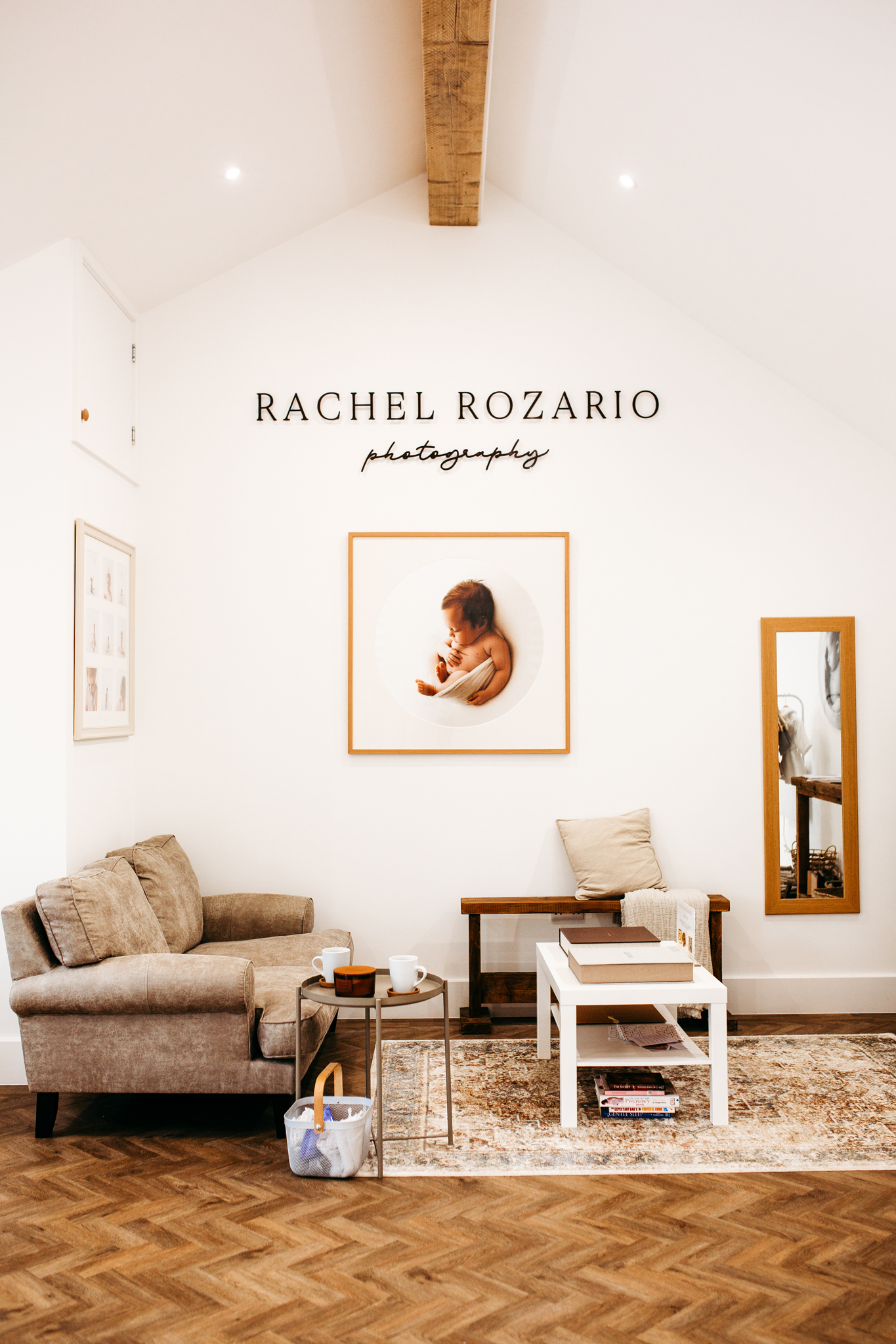Photography of wall art and client seating area in Rachel Rozario's photography studio on the Wirral.